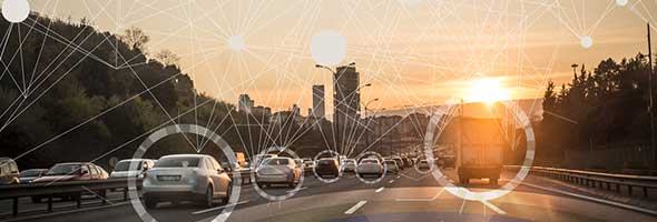 Autos auf der Strasse, die in den Sonnenuntergang fahren